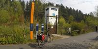 An old watchtower and the orange stele on the Berlin Wall Trail