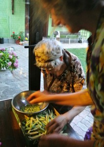 The author's mother shelling peas with a local lady