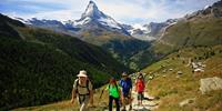 Hikers walking above Zermatt with the Matterhorn in the distance