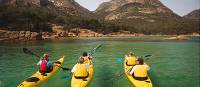 Kayaking the crystal clear waters of the Freycinet Peninsula on Cycle, Kayak and Walk Tasmania