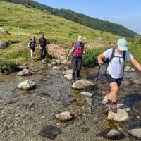 Crossing a stream on the peaks of the Balkans trail