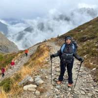 A woman trekking the Tour du Mont Blanc in Switzerland