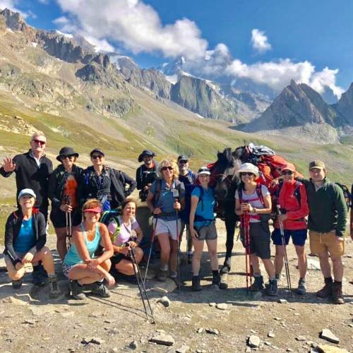 Group posing at the Italian-French border in the Alps
