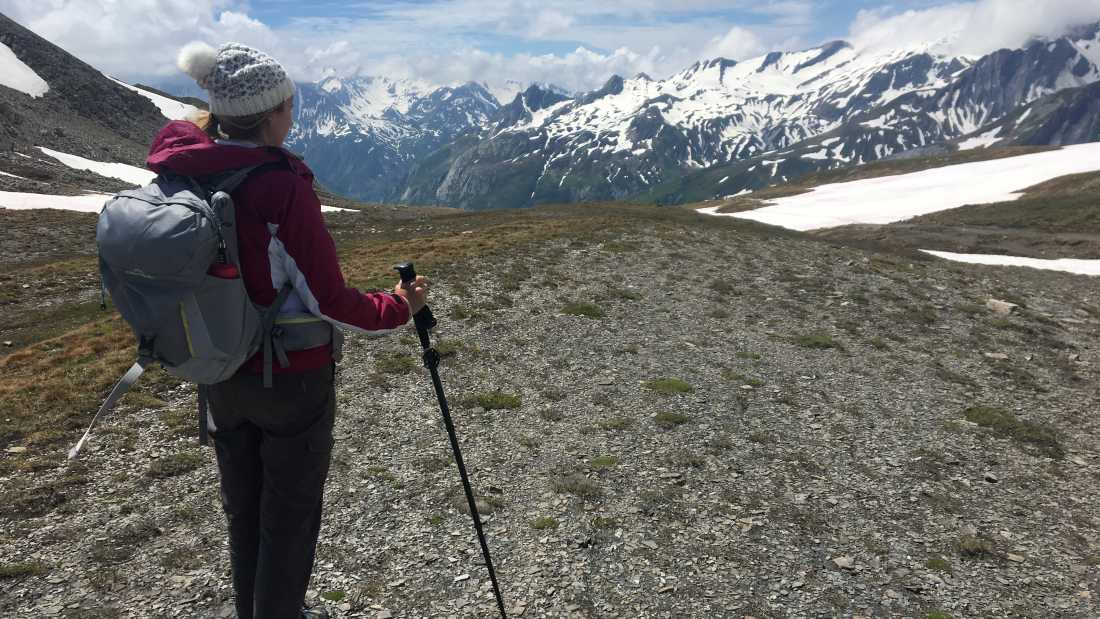 A hiker stopping to appreciate where they've just come from |  Allie Peden