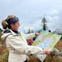 Woman reading a map of the TMB during a lunch break