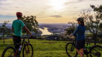 Cyclists admiring the sunset over the Danube