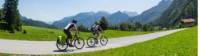 Cycling towards crisp mountain skyline