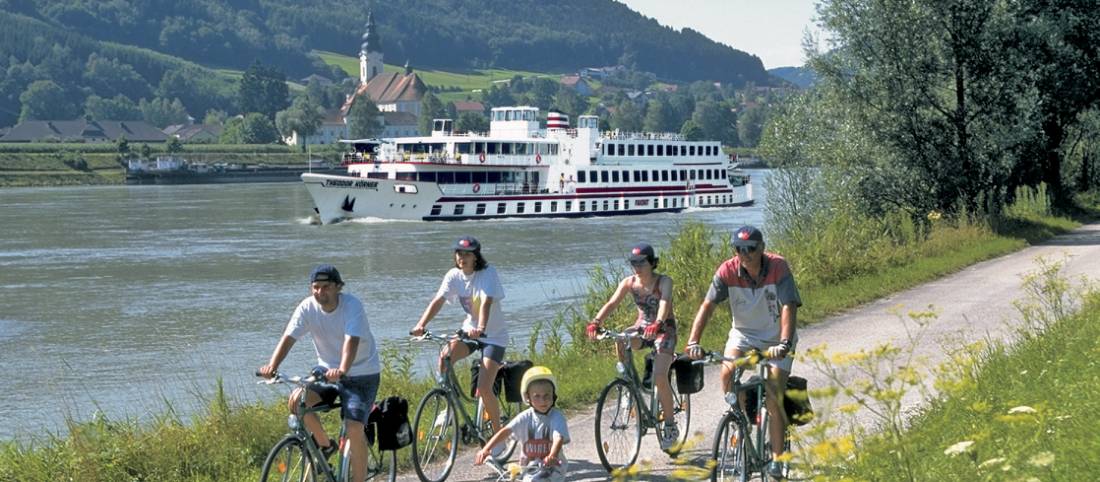 Family cycling along Danube