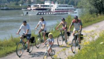 Family cycling along Danube