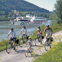 Family cycling along Danube