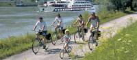 Family cycling along Danube