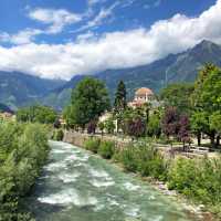 The Passer River winds through the heart of Merano, framed by alpine peaks