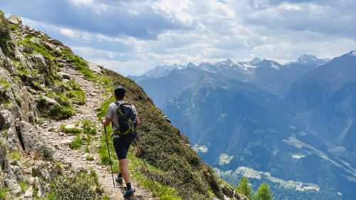 Hiker on the Passeier Valley trail beneath the peaks of South Tyrol