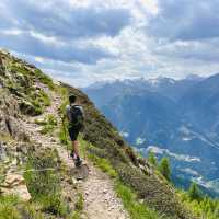 Hiker on the Passeier Valley trail beneath the peaks of South Tyrol