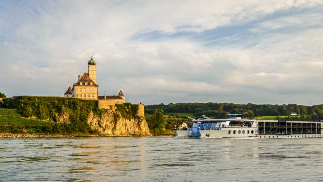 Barge crossing by Schonbuhel Castle on the Danube river