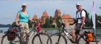 Cyclists in front of Trakai Castle, Lithuania