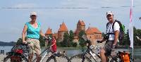 Cyclists in front of Trakai Castle, Lithuania