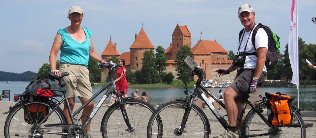 Cyclists in front of Trakai Castle, Lithuania