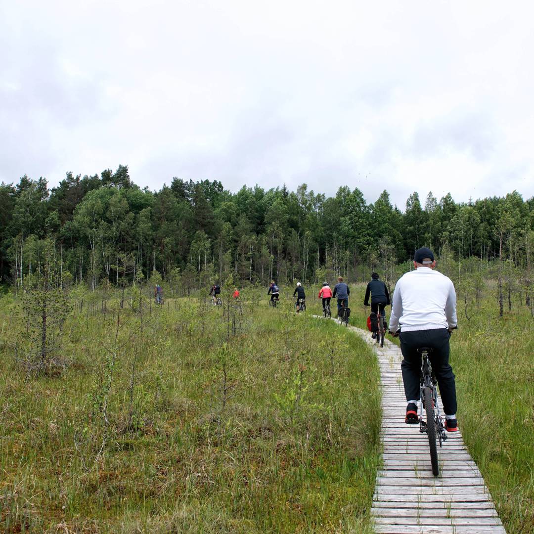 A group cycles through the countryside in Lithuania