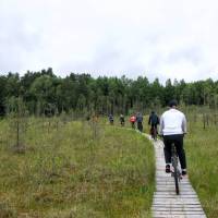 A group cycles through the countryside in Lithuania