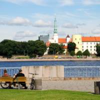 Cyclists admiring Riga Castle in Latvia