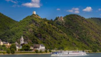 MS Olympia sails past a castle