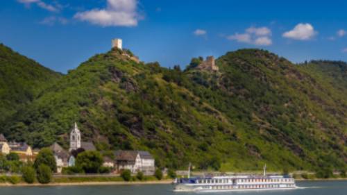MS Olympia sails past a castle