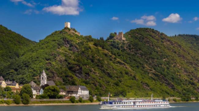 MS Olympia sails past a castle