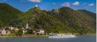 MS Olympia sails past a castle