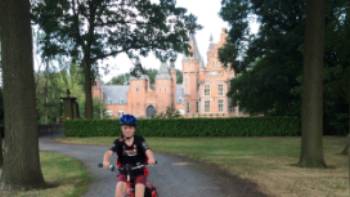 Cycling at Ghent,Hilary Delbridge Young cyclist outside a castle near Ghent
