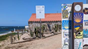 Following the Camino shell signage, which points travellers in the right direction.