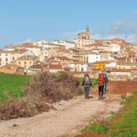 Pilgrims entering the Spanish town of Cirauqui on the Camino | Burkard Meyendriesch