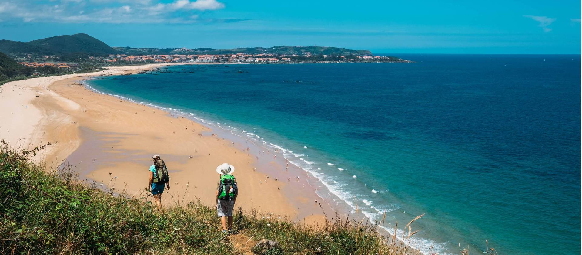 Walking onto Noja beach on the Camino Norte in Spain