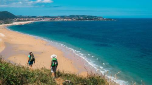 Walking onto Noja beach on the Camino Norte in Spain