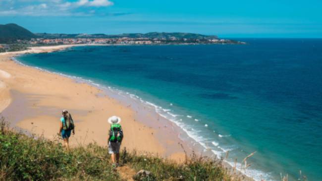 Walking onto Noja beach on the Camino Norte in Spain