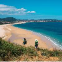 Walking onto Noja beach on the Camino Norte in Spain