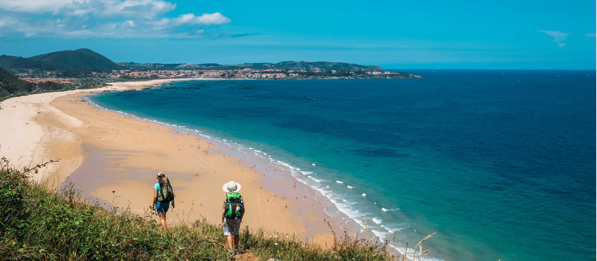 Walking onto Noja beach on the Camino Norte in Spain