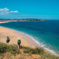 Walking onto Noja beach on the Camino Norte in Spain