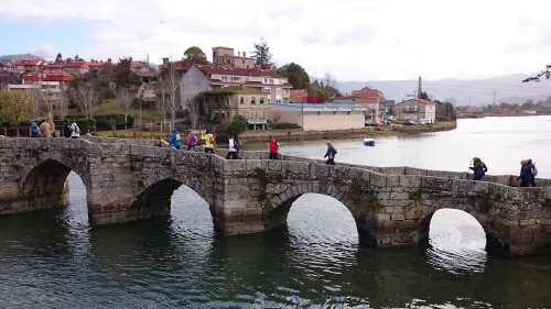 Pilgrims crossing a bridge along the Portuguese Way