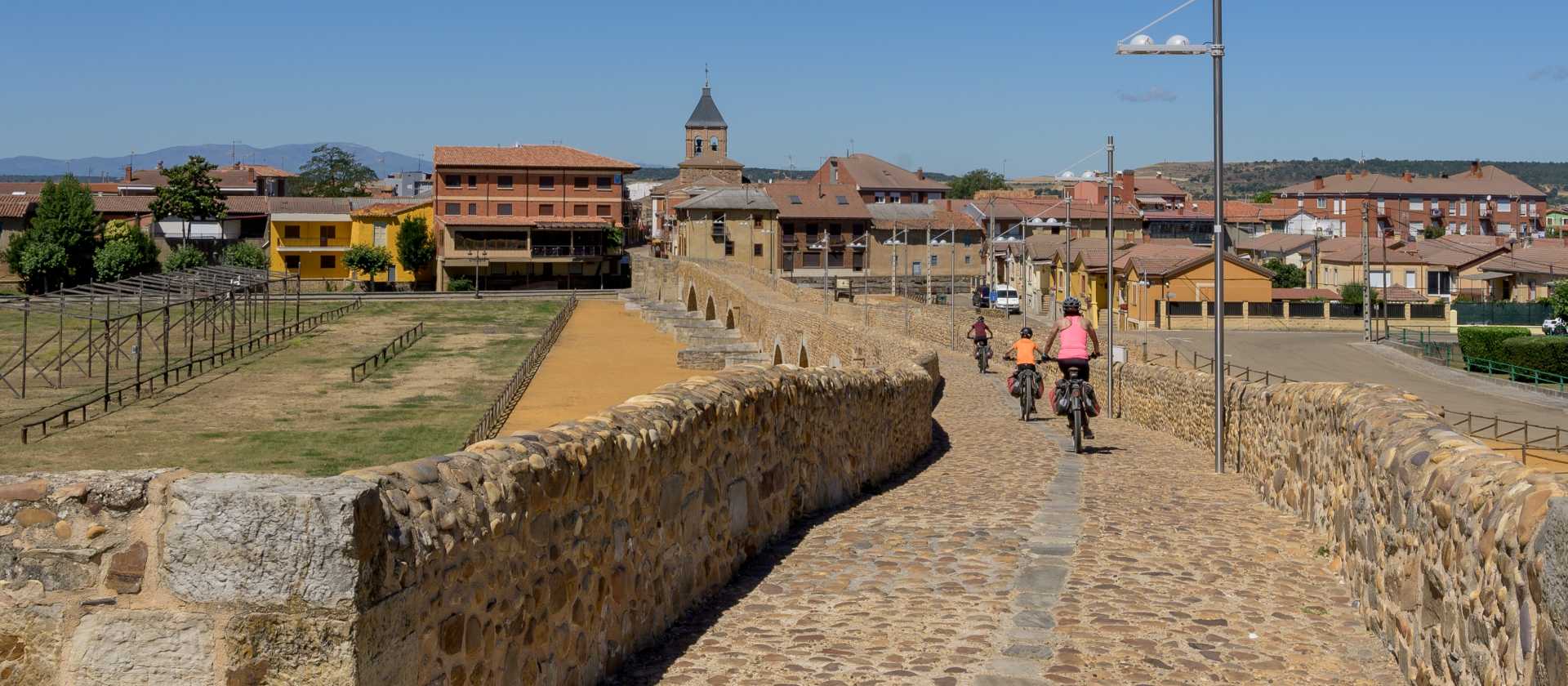 Cycling over the famous Camino bridge of Orbigo