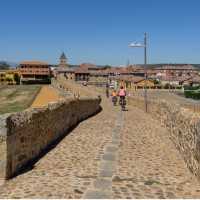 Cycling over the famous Camino bridge of Orbigo