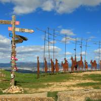 Find the iconic Alto del Perdon Camino art near Pamplona