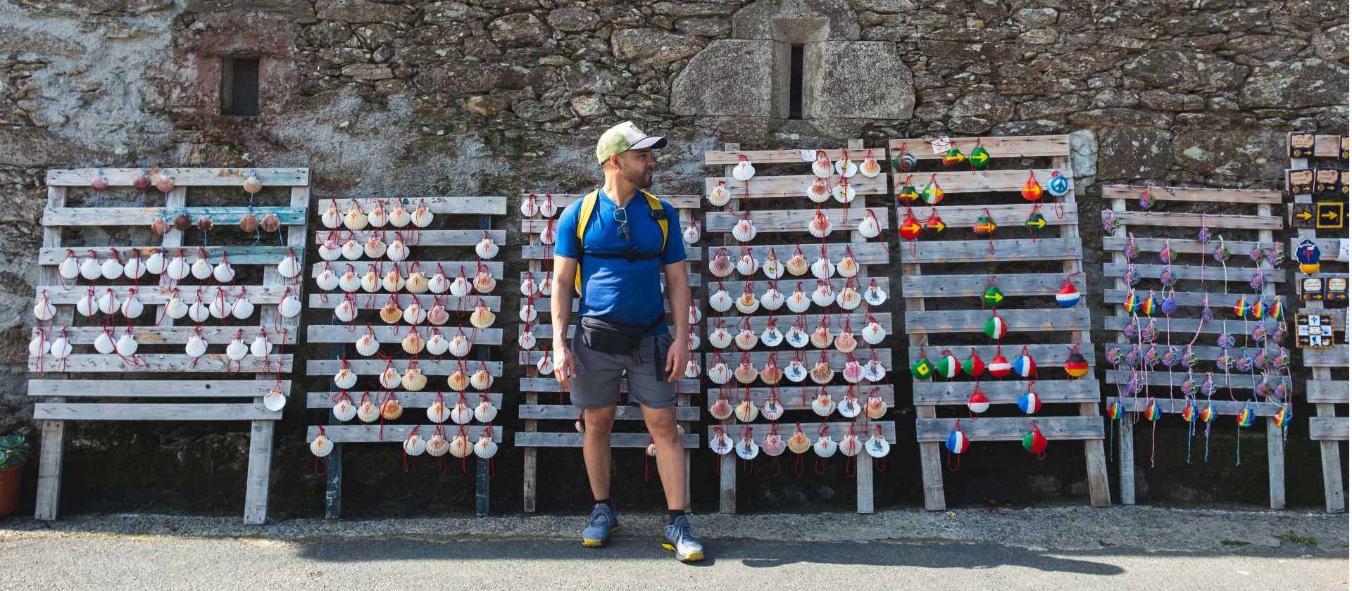 A pilgrim choosing which shell to carry on the Camino de Santiago