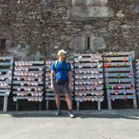 A pilgrim choosing which shell to carry on the Camino de Santiago