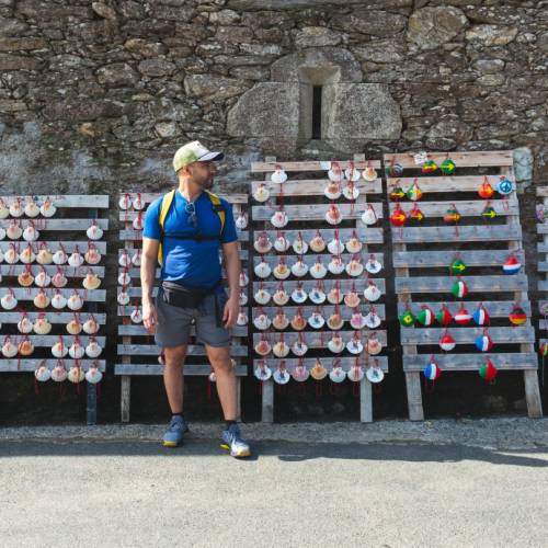 A pilgrim choosing which shell to carry on the Camino de Santiago