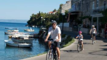 Cycling past boats on the Croatian islands with kids