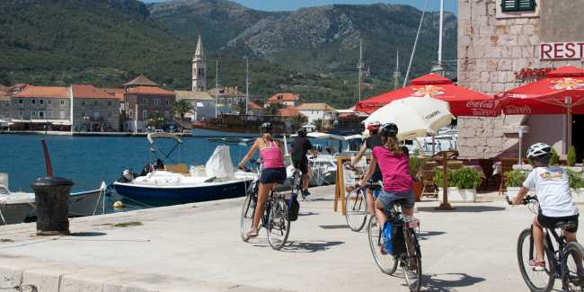 Children cycling into the town of Jelsa on the island of Hvar