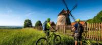 Cycling by a windmill in the Czech Republic | Petr Slavík