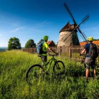 Cycling by a windmill in the Czech Republic | Petr Slavík