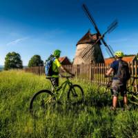 Cycling by a windmill in the Czech Republic | Petr Slavík